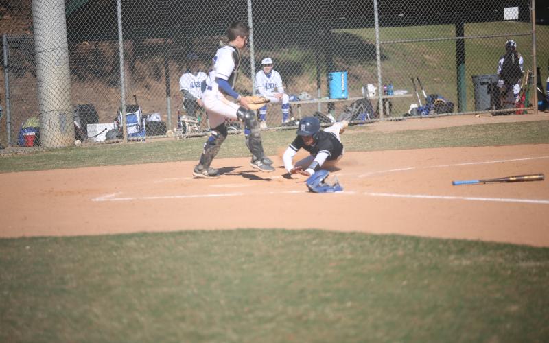 Jose Rodriguez dives for the plate as the Barrow catcher tries to apply a tag during Elbert’s win over Barrow.  (Photo by Wells)