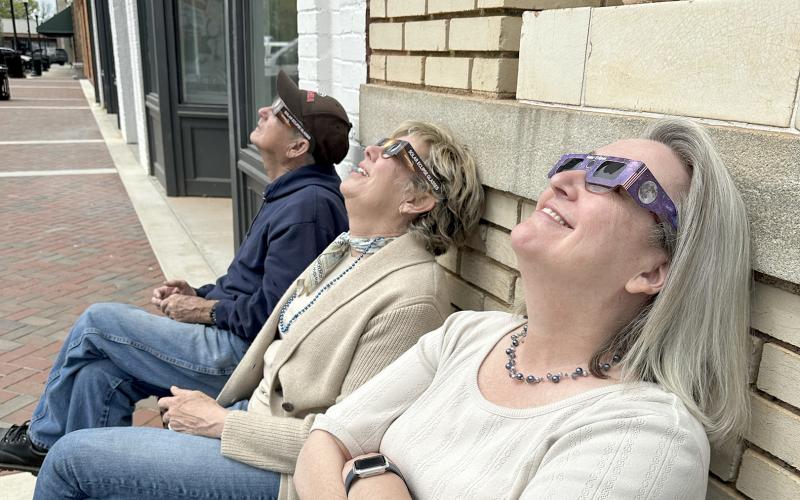 Members of The Elberton Star staff (right, L-R) Earl Saxon, Valerie Evans and Barbara Slay enjoyed viewing the eclipse (left) with safety glasses. (Photo by Scoggins) 