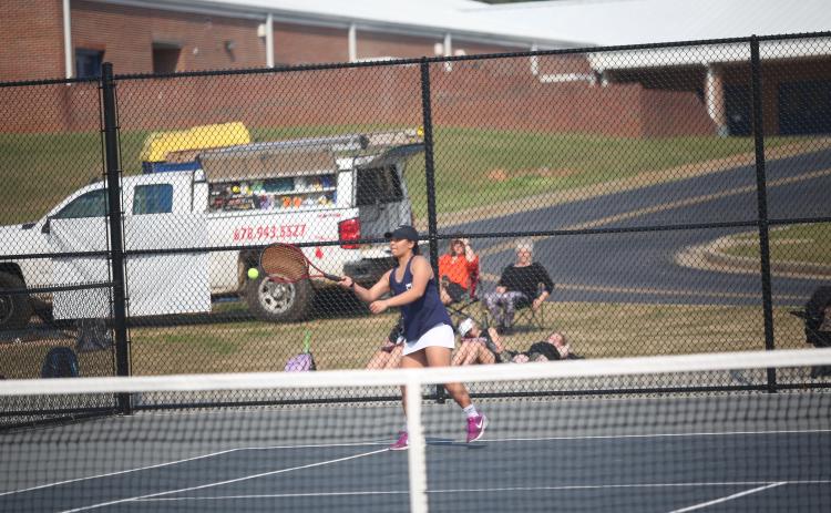 Lady Devil senior Katie Nguyen returns a serve during a March 21 match against Hart County. The Devil and Lady Devil seniors were recognized prior to the start of this year’s region tournament. (File photo by Wells)
