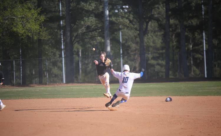 Brayden Ingram finishes off the second-half of a double play by throwing over to first after making a leaping catch to field the ball and tag second base for the first out. (Photo by Wells)