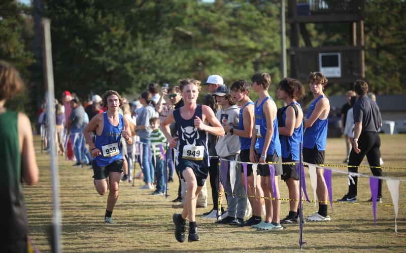 Ezra Adamson beats a Barrow runner to the finish line during the Region 8A Division 1 championship meet Oct. 26. (Photo by Wells) 