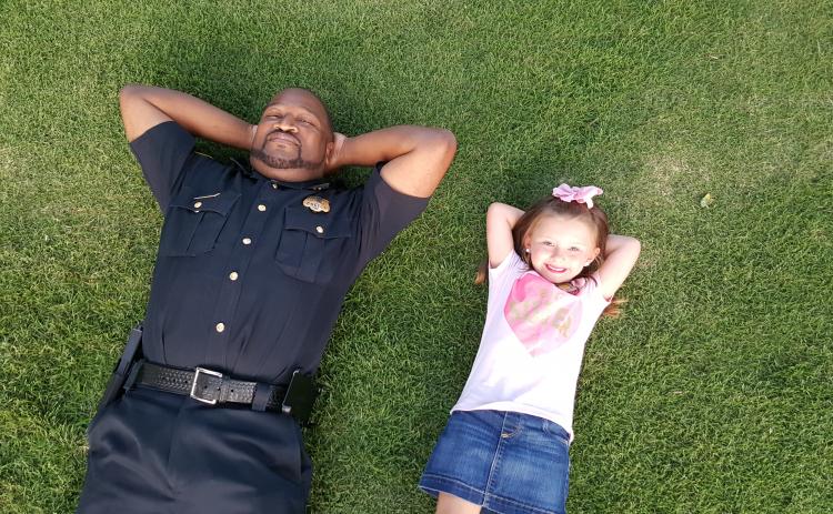 aking it easy is Elberton Police Capt. Darin Rucker (left) and a friend, Aspen Wright, who are relaxing after an event Rucker conducted as a part of the Elberton Police Department’s relationship-building efforts in the community.