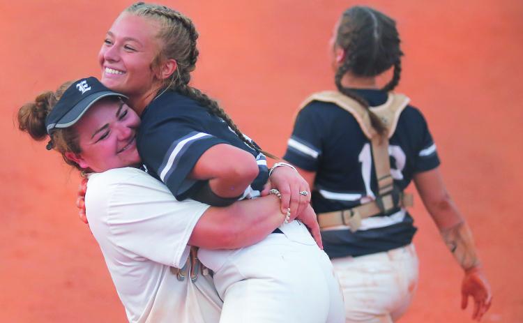 Lady Blue Devil assistant coach Katie Archer (left) and senior pitcher Lauren Hart react during Elbert County’s 11-1 victory at Clarke Central High School  Sept. 4 in Athens (Photo by Cary Best)
