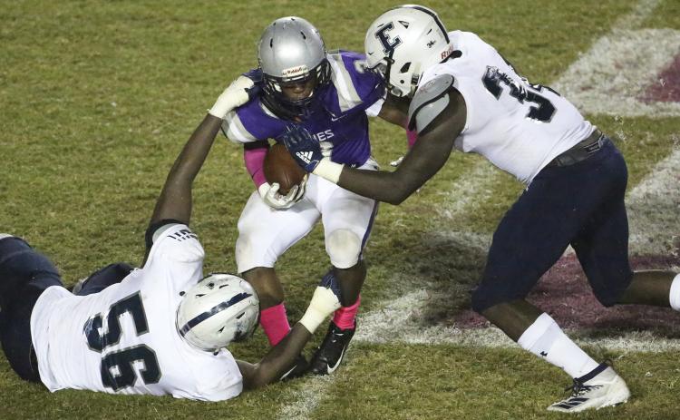 Blue Devil linemen Marlin Dean (left) and Tobias Jones tackle Hurricane running back Shamarian Greene during Elbert County’s 35-18 Region 8-AA win  at Monticello Oct. 25. (Photo by Dan Giles)