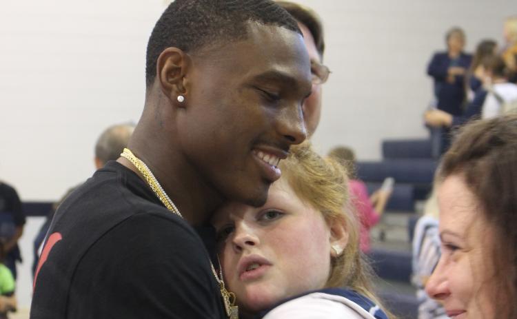 Kansas City Chiefs wide receiver Mecole Hardman surprised everyone by showing up at Elbert County Middle School Friday after a Thursday night NFL game in Denver. Among the many who got to greet Mecole was Marti Love Terrell.  Hardman also participated in a Friends Helping Friends basketball game. (Photo by Scoggins)