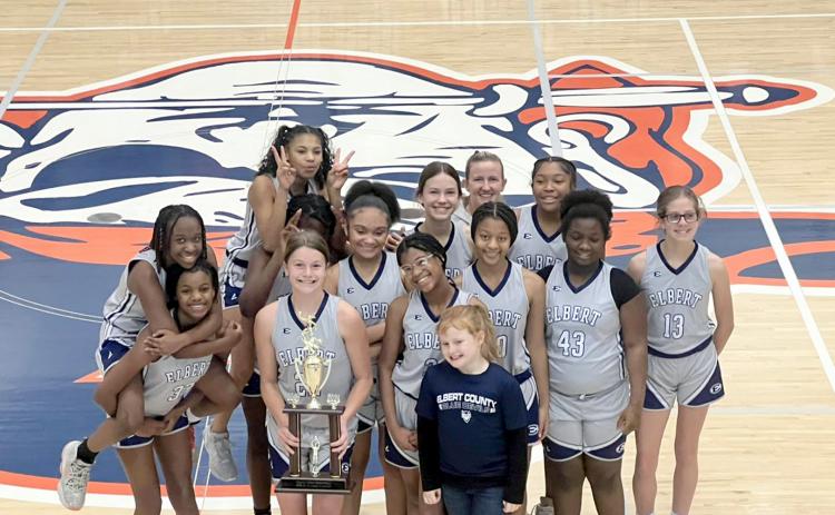 The seventh grade Lady Rams team poses with their championship trophy after defeating Madison County 34-30 Jan. 20. (Photo courtesy of Donna Baker))
