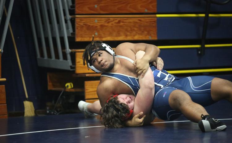M.J. Cook pins an opponent during his first match of the Inferno Invitational Jan. 27. Cook was among a group of five Devils who finished in second during the event. (Photo by Wells)
