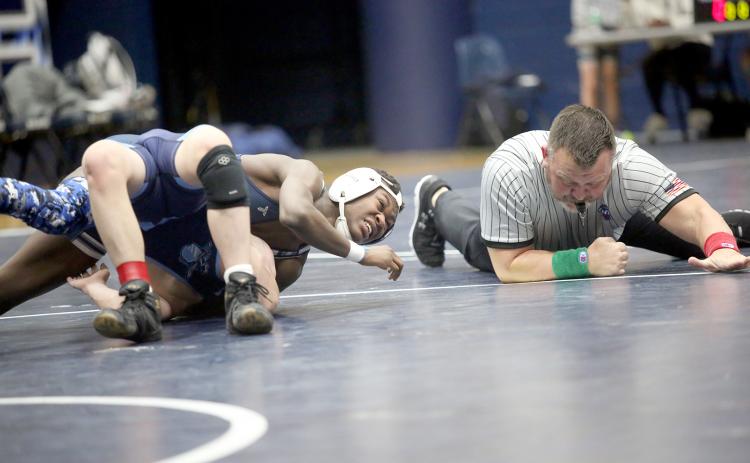 The referee slaps the mat as Bry Harper pins an opponent during Elbert’s dual against Johnson Jan. 17. (Photo by Wells)