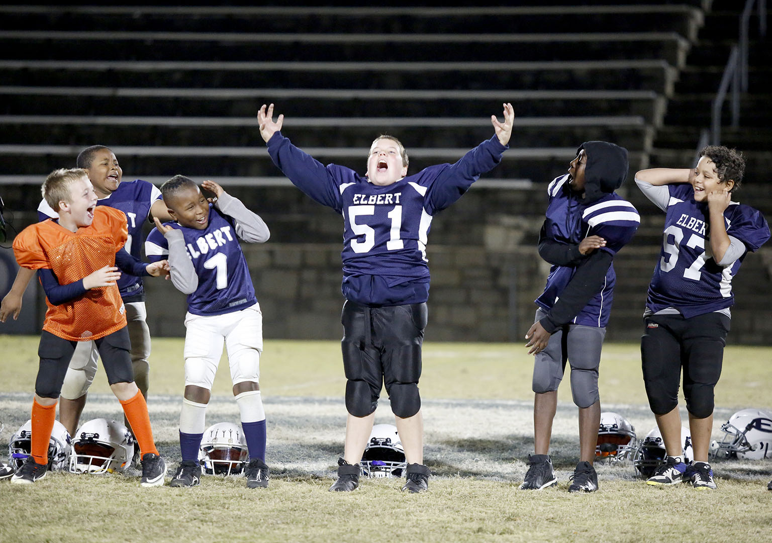 10U Elbert County Blue Devils (L-R) Chance Duck, Landon Newsome, JaMain Crosby, Justin Cleveland and Hayden Huff react to No. 51 Cole Freeman’s roar while being recognized during the community pep rally for the Elbert County Parks and Recreation teams Thursday, Nov. 18 in the Granite Bowl. (Photo by Scoggins)