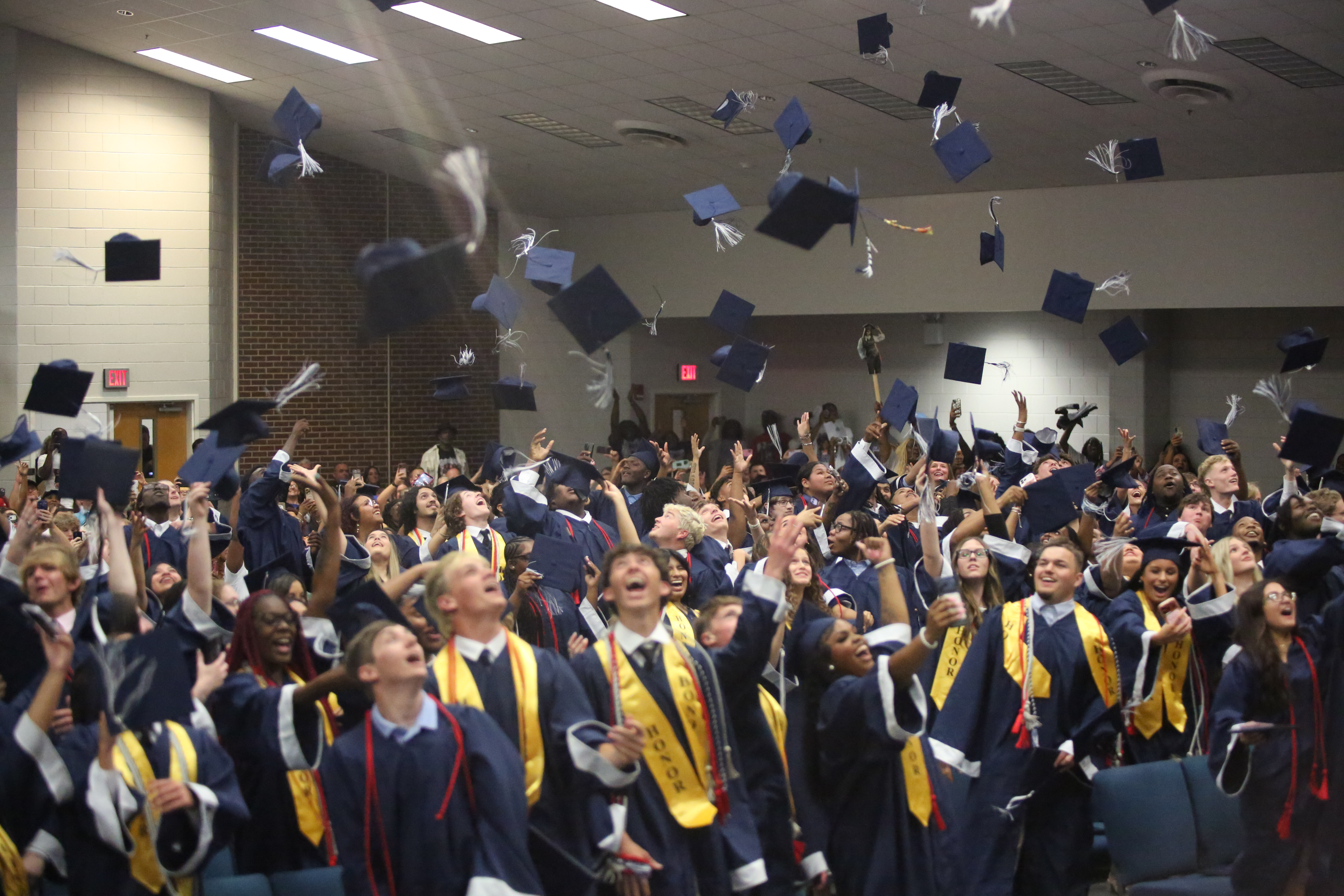 The Elbert County Comprehensive High School Class of 2026 dodged some rainy weather and held their graduation ceremony inside Elbert County Elementary School May 22. Regardless of the venue change the class was unable to resist the urge to toss their caps in the air after the completion of the ceremony. (Photo by Bo Underwood)