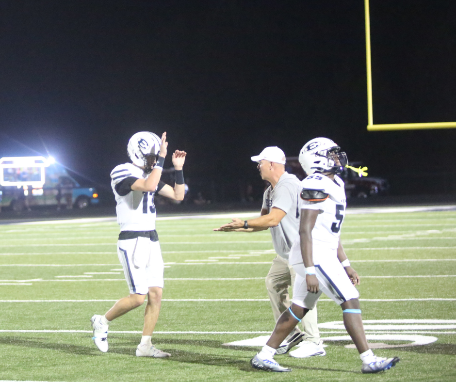 Quarterback Brody Baker and head coach Andy Dyer high-five following Elbert’s win over East Jackson. (Photo by Bo Underwood)