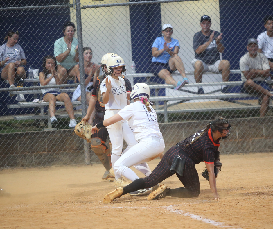 Ansley Harris celebrates with Haley Jones after sliding safely into home plate. (Photo by Bo Underwood)