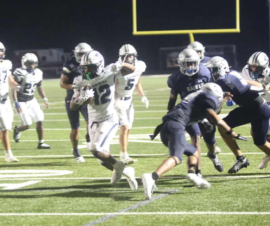 Exzavier Jones (12) makes a man miss on his way to the end zone. (Photo by Bo Underwood)