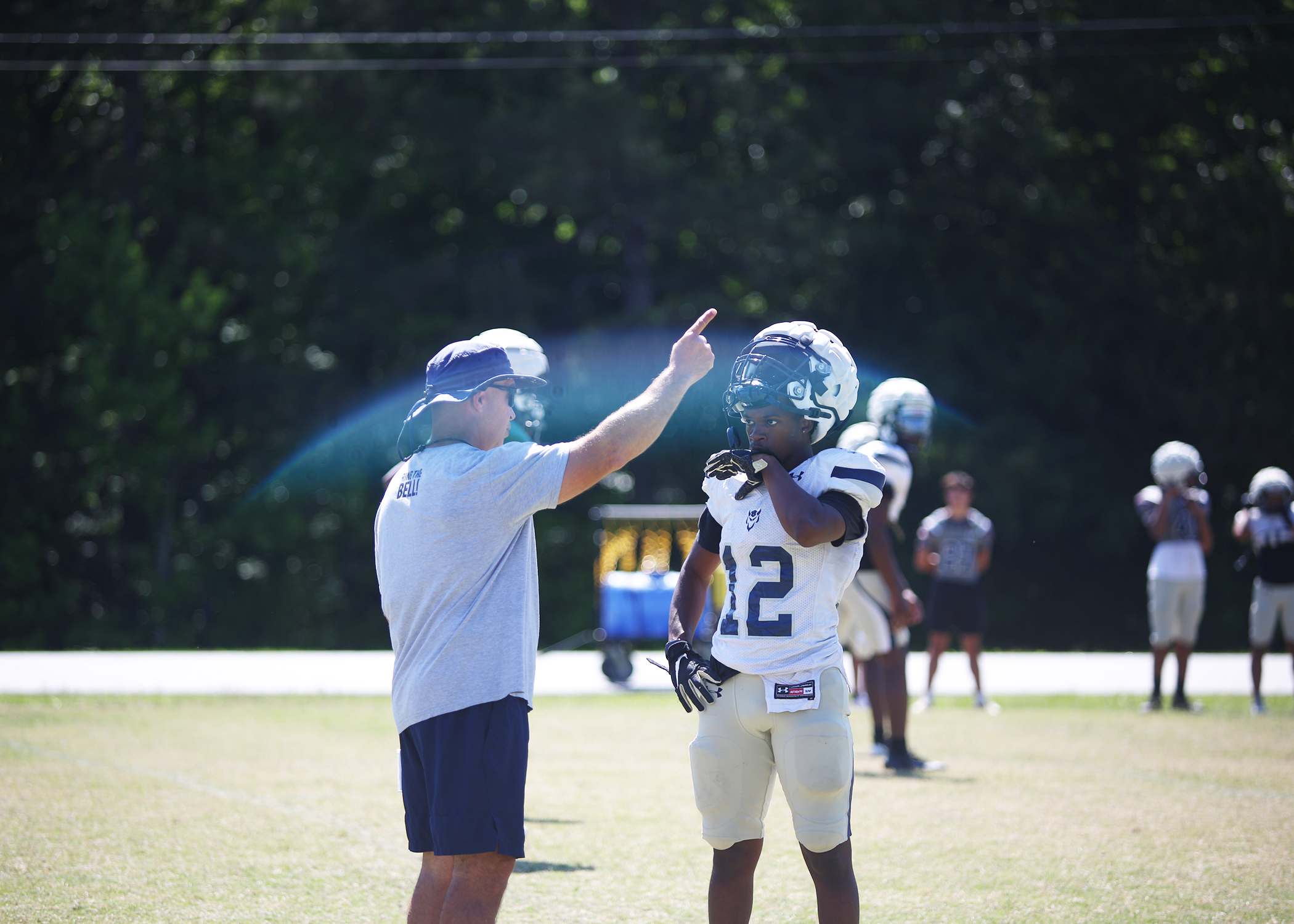 Head coach Andy Dyer instructs (12) Exzavier Jones at spring practice (Photo by Bo Underwood).
