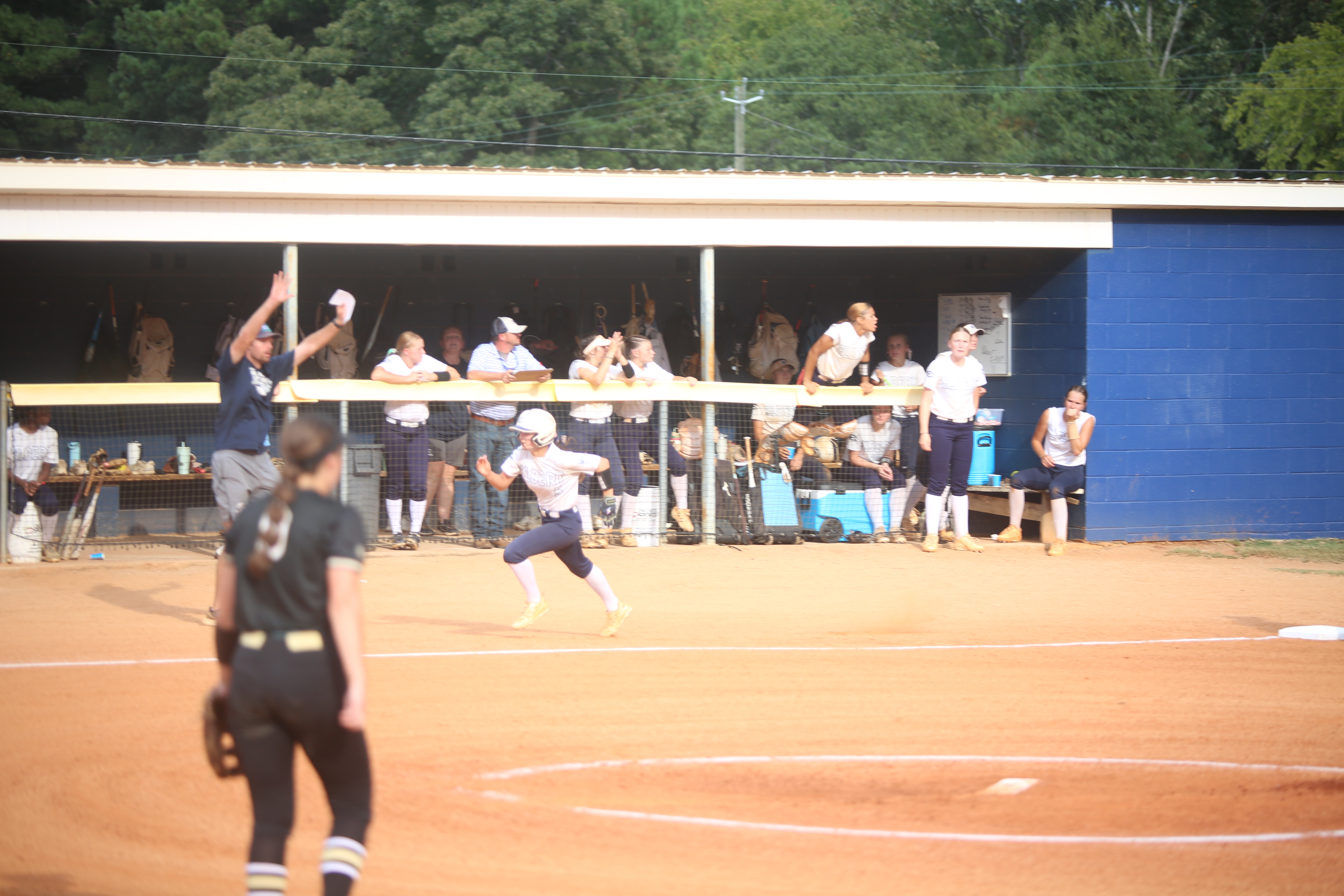 Bellamy Nash runs home as Bryce Bowen holds the other runner. (Photo by Bo Underwood)