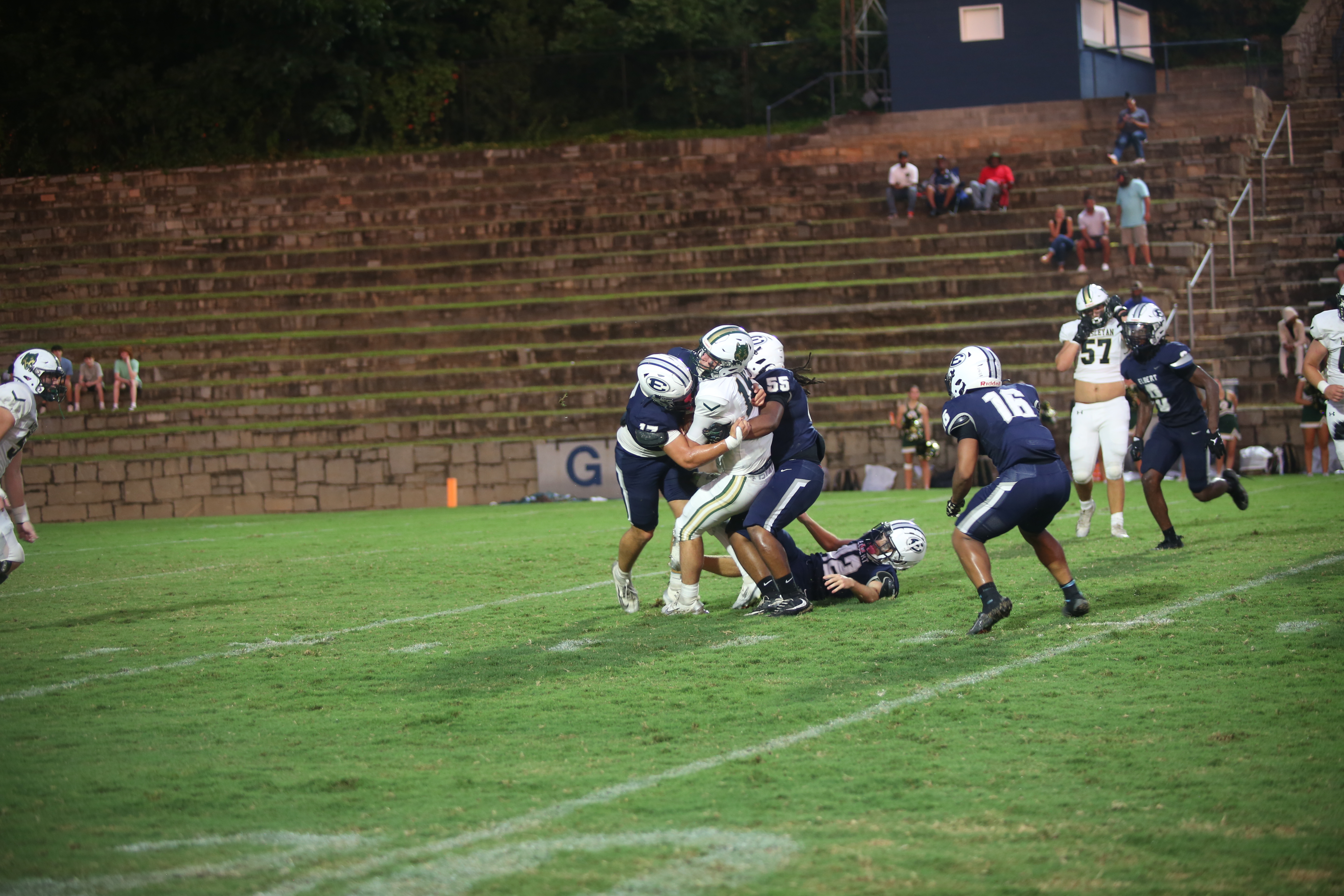 Kaden Montgomery (17) and Chance Ardister (55) sack the quarterback. (Photo by Bo Underwood)