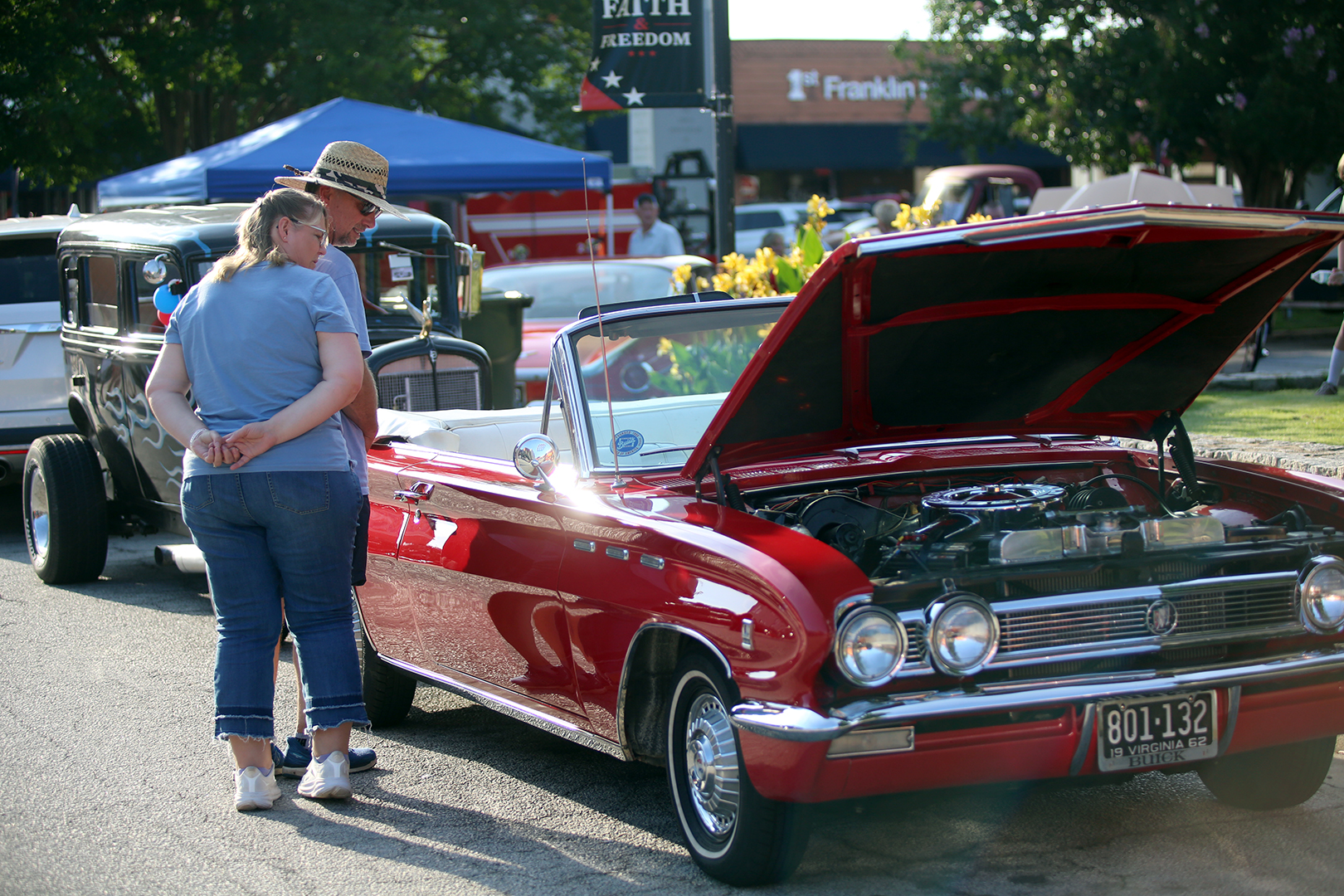 A pair of car enthusiasts check out a classic Buick during the annual Cruise-In Car Show July 18. A total of 140 cars of every variety registered for the show. See more photos on Page 16 of this week's edition (Photo by Mark Wells)