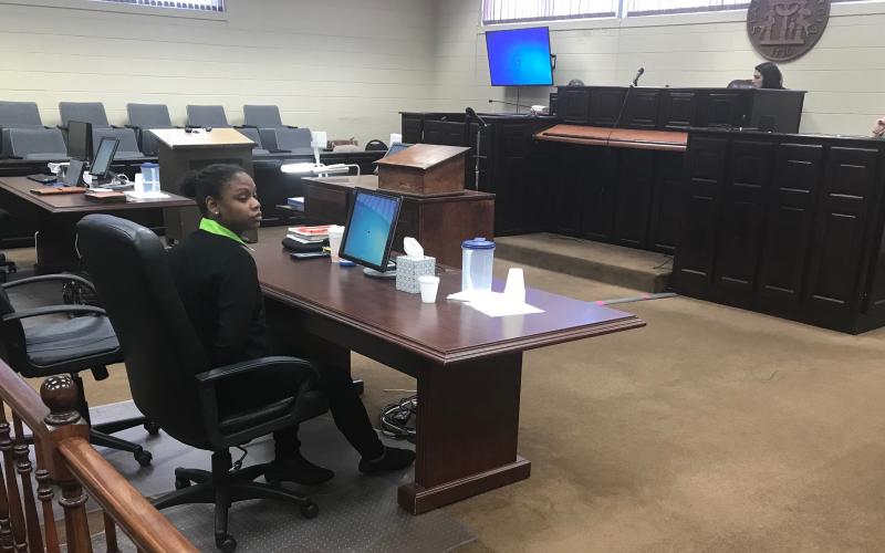 Savanna Marrie Jennings sits alone, handcuffed by Scott Franklin of the Elbert County Sheriff’s Office, shortly after a jury convicted her on seven charges, including malice murder and felony murder, in the death of Otha Perrin in 2018. She was also found guilty on two counts of aggravated assault, two counts of possession of a firearm or knife in the commission of a felony and concealing the death of another. (Photo by Jones)