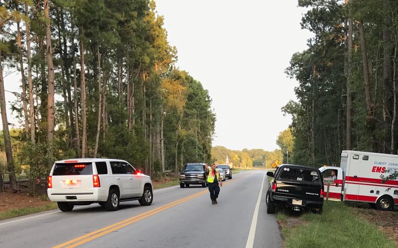 Elbert County personnel remove the body of a 51-year-old woman from a Bowman Highway residence early Sunday evening. (Photo by Jones)
