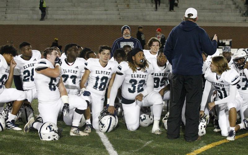 Head football coach Brad Waggoner (left) delivers his last post-game speech of the season after Elbert County fell 48-21 to Frederick Douglass Nov. 16 at Lakewood Stadium in Atlanta.