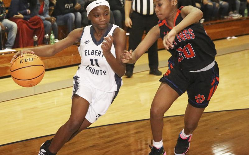 Freshman Lady Blue Devil point guard Terrace Hester (left) drives past Lady Jaguar Deneshia Roach in Elbert County’s 46-42 win over Cedar Shoals Dec. 20 in Elberton. (Photo by Dan Giles)