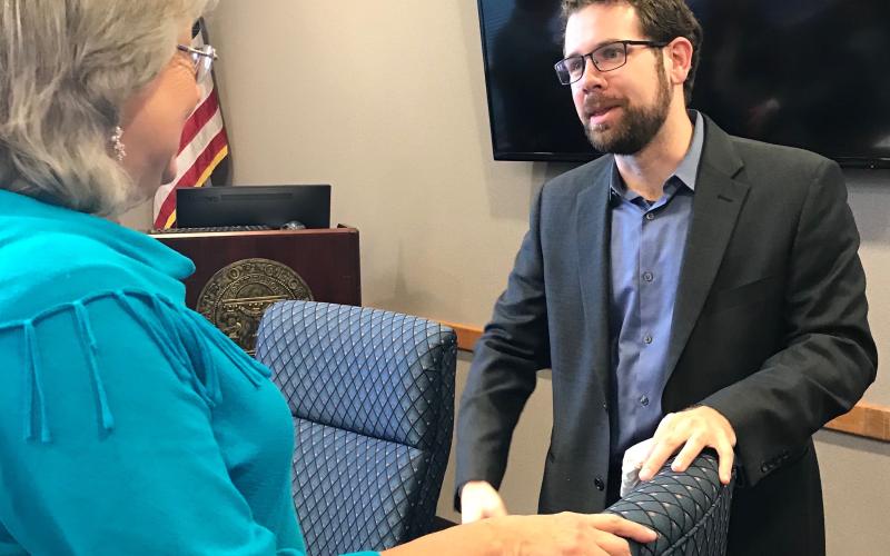 Daniel Dobbins (right), hired unanimously by the development authority Thursday, talks with authority member Leona Brown. (Photos by Jones)