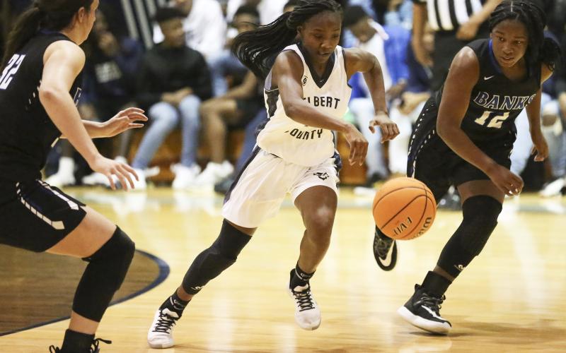 Lady Blue Devil freshman Terrace Hester (center) splits two Lady Leopard defenders during Elbert County’s 51-44 win over Banks County Jan. 24 in Elberton. (Photo by Dan Giles)