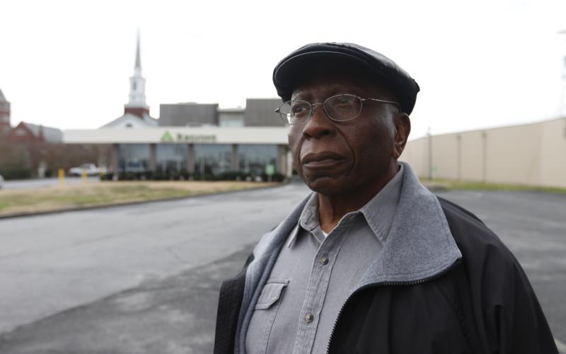 Randolph Davis (top) looks toward Elbert Street as he stands in front of Regions Bank. Davis’ father’s barbershop and other African-American businesses sat on the property where the bank is now before the street was widened in the 1960s. (Photo by Scoggins)