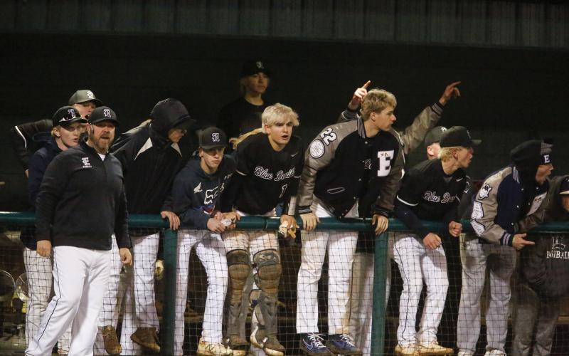 Diamond Devil head coach Lance Ingram and players (L-R) Storm Mills, Branson Mills, Austin Duck, Caden Brown, Cole Hudson, Jordan Mills, Carter Dye, Carson Adams and Kyle Moon react to tying the Eagles 3-all during the fourth inning of Elbert County’s 5-4 loss to Athens Christian Feb. 21 in Athens. (Photo by Cary Best)