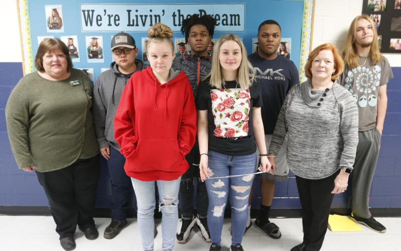 Mountain Education Center offers ‘a lot more support here;’ Shown are (L-R) Mountain Ed Administrator Laura Lynch, Emmanuel Kim, Faith Carey, Miles Plummer, Emma Smith, Brandon Heard, Mountain Ed Administrator Renee Padgett and Seth Adams. (Photo by Scoggins)