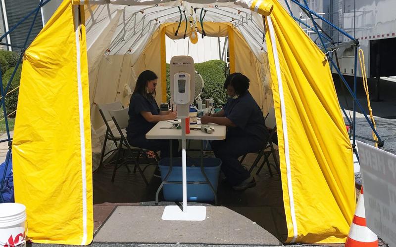 Andrea Webb (left) and Margie Rucker are screening all persons entering Elbert Memorial Hospital in a tent outside of the hospital’s emergency room. (Photo by Jones)