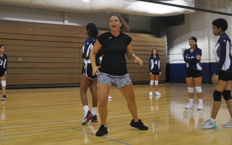 Erica Wilson works on front line play with Elbert County volleyball team members last week on the newly reconditioned floor at the high school. The Lady Devils will open the season against Athens Christian Monday beginning with a junior varsity match at 5 p.m. (Photo by Jones)