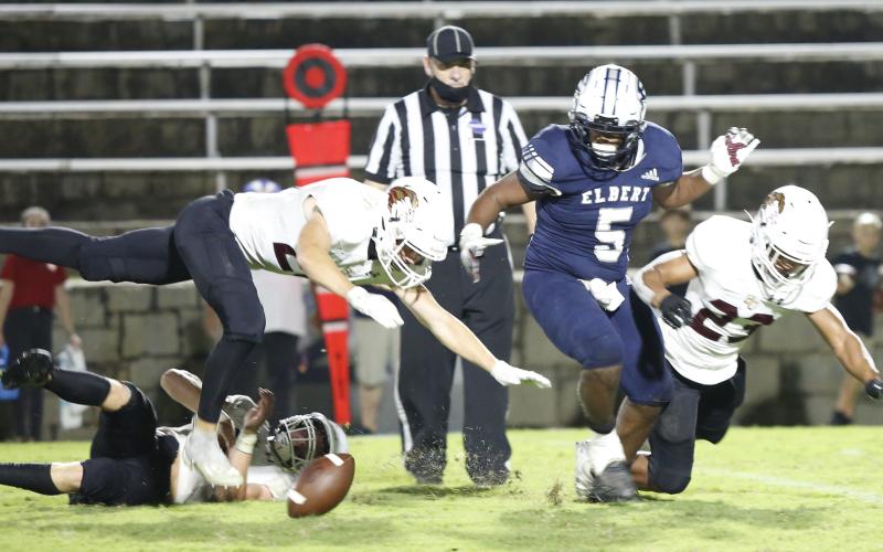 C.J. Tate (No. 5) and an abundance of Lions from Hebron Christian Academy start a scramble for a fumble.  For the second week in a row, Elbert County’s offense suffered through turnovers throughout the game, prompting Head Coach Shannon Jarvis to promise to work on “fundamentals” in preparation for a Friday night appearance against Commerce’s Tigers in Commerce. (Photo by Scoggins)