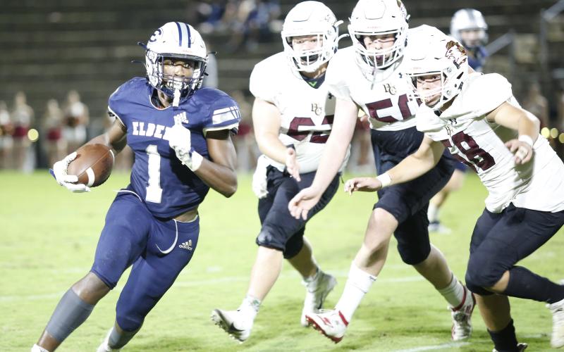 Elbert County Blue Devil sophomore running back Quan Moss (No. 1)  searches for running room Friday night in the Historic Granite Bowl against Hebron Christian Academy. (Photo by Scoggins)