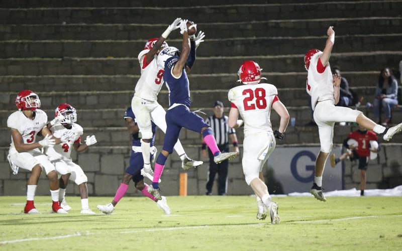 Christian Harris (above) latches on to a Braydon Scarborough pass as the clock runs out in Friday night’s 27-20 loss to Lincoln County in the Granite Bowl. (Photo by Scoggins)