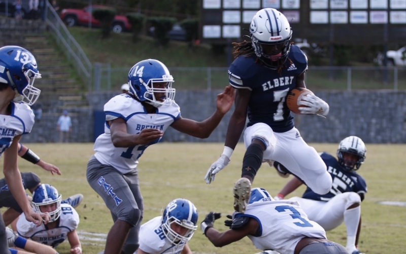 Q.T. Teasley leaps over a defender Saturday in the Granite Bowl. Playing in his final game in the Historic Granite Bowl, Teasley caught two passes for 41 yards against Bremen in the state playoffs.  (Photo by Scoggins)