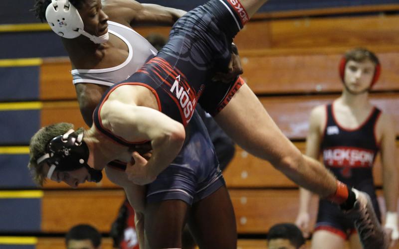 Senior Jamal Rucker takes down his opponent from Jackson County during the Granite City Scramble in the Inferno Dec. 12. (Photo by Scoggins)