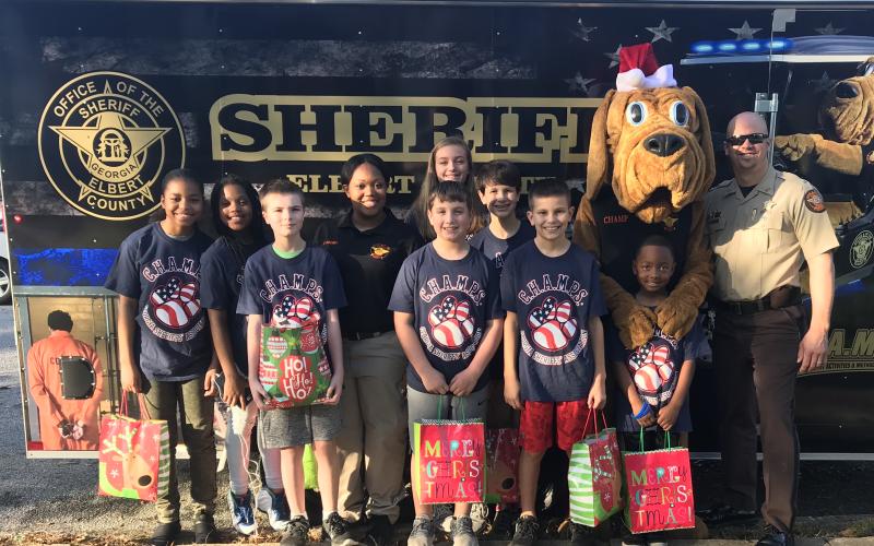 Elbert County Sheriff’s Office Lt. Marc Fleming, shown at the far right prior to a Christmas parade in Elberton, said his work as a school resource officer was the “best way to make a difference in the community.’ That ended Wednesday when the 14-year law enforcement veteran received a one-day notice by certified mail that Sheriff Melvin Andrews was firing him.