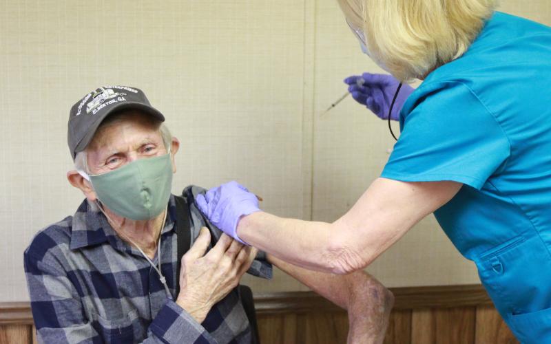 Billy Scoggins of Dewy Rose received the Pfizer COVID-19 vaccine from The Medical Center’s Tina Mewborn at The Medical Center’s COVID-19 vaccine facility Jan. 13. The Medical Center announced Jan. 4 they were accepting appointments for established patients ages 65 and older by calling 706-283-3315. (Photo by Scoggins)