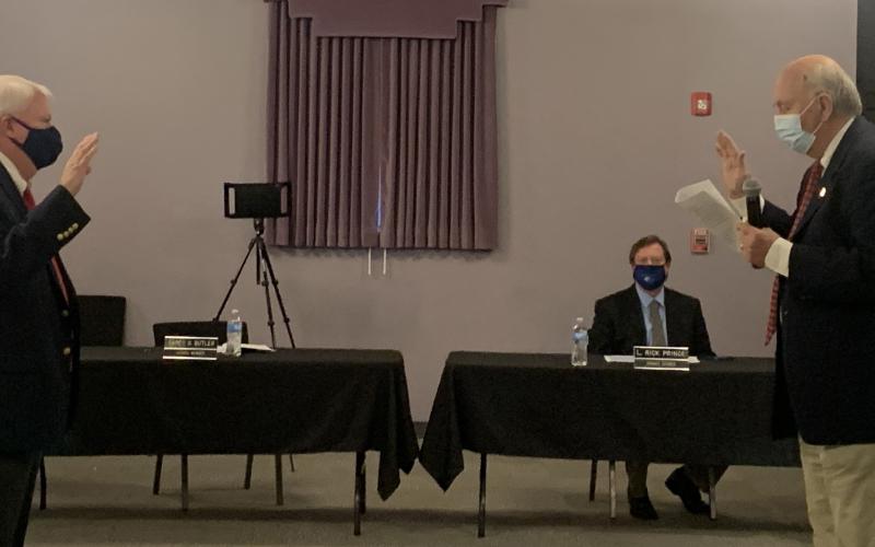 Mayor Larry Guest swore in Mayor Pro Tem Carey Butler Monday night in the first meeting of the year for the council. The meeting was held in the Elberton Arts Center and as you can tell from the swearing in ceremonies, the council used social distancing protocols. (Photo by Scoggins)