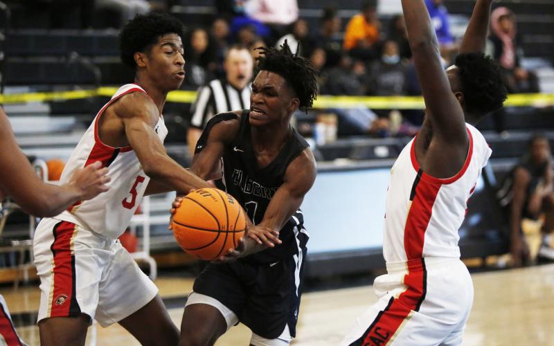Jaelin Webb attempts to make a pass in heavy traffic in the McDonald’s Shootout Tournament at Hart County High School in Hartwell Monday. (Photo by Scoggins)