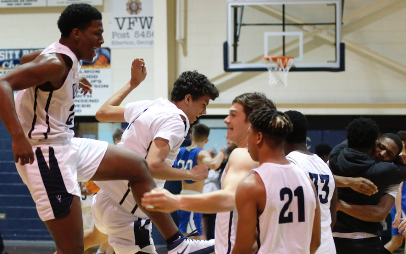 Sophomores Quon Moss (far left) and Kane Hughes and juniors Bryce Dickerson and Trustin Allen (21) jump for joy after the Devils’ 89-85 victory over Banks in double OT Jan. 22 in the Inferno while juniors Jamil Burton and A.J. Henderson celebrate with a hug. (Photo by Scoggins)