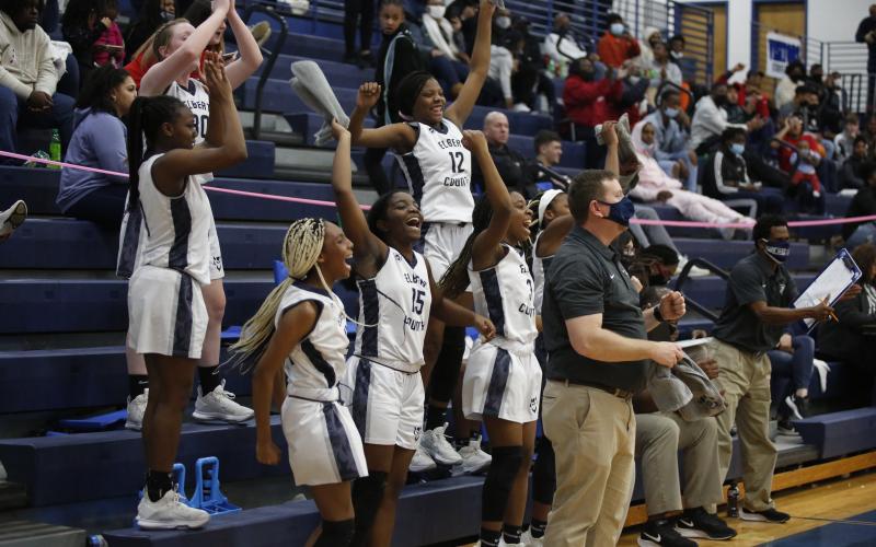 Sophomores (L-R) Lilly Ray, Terrace Hester, Niya Moon, junior Jordan Glaze, sophomores Brenasia Faust and Aaniyah Allen and Head Coach Josh Jones react to a score from senior Jedihah Williams in the Lady Devils’ competition against Union County during the Region 8-AA Tournament at Banks County Friday, Feb. 12. (Photo by Scoggins)