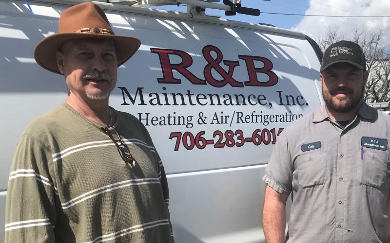 Following in the footsteps ... Cole Ferrell (right) started working with his father as soon as he could drive an R&amp;B Maintenance truck. (Photo by Jones)