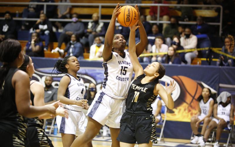 Lady Devil Jameria Allen watches as Jordan Glaze attempts to put up a shot against the Temple Lady Tigers during the first round of the GHSA state playoffs in the Inferno Tuesday, Feb. 23. By defeating the Lady Tigers 52-14, the Lady Devils advanced to the Sweet Sixteen, where they defeated South Atlanta 62-28 Friday, Feb. 26. (Photo by Scoggins)