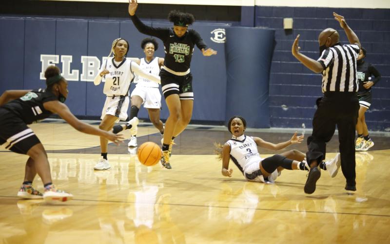 Niya Moon (21), Jamia Allen and Aaniyah Allen (3) react after Aaniyah was knocked to the ground by a referee during Tuesday’s 46-45 loss against Josey in the playoffs. (Photo by Scoggins)