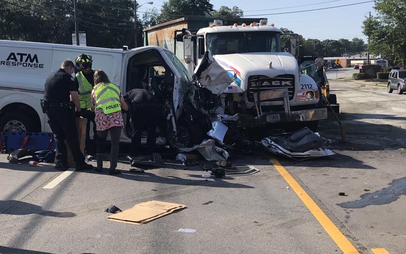 College Avenue, the main artery through Elberton on the west side of town, was closed to all traffic during most of the morning on Wednesday, June 16. Authorities still aren’t sure why the reinforced “ATM Response” van on the left crossed from the eastbound lanes of College Avenue turning lane,  through the turning lane and into the westbound side. Three men  were transported to hospitals after the accident. (Photo by Jones)