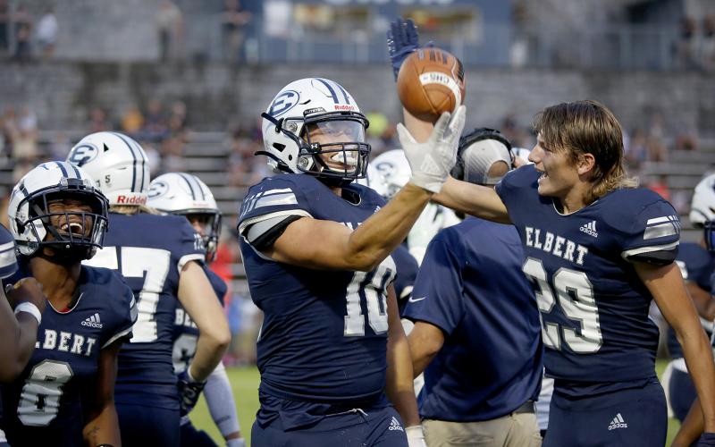 Fuquan Hargrove (No. 8) and brothers Bryce Dickerson (No. 10) and Brady Dickerson (No. 29) celebrate Bryce’s fumble recovery that led to the Blue Devils’ first score of Friday’s 27-14 victory over Commerce in the Granite Bowl. (Photo by Scoggins)