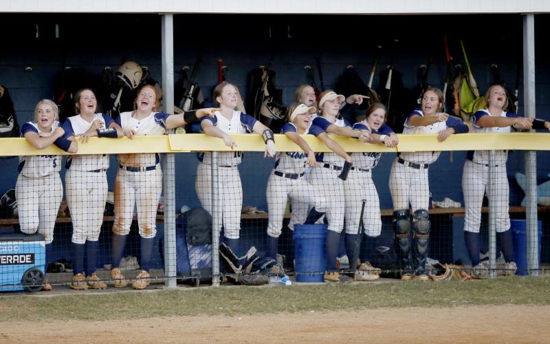 Lady Devils Chesnee Brown, Dallas Dean, Ava Lunsford, Lilly Ray, Gracie Brady, Jayda Wood, Miller Drake, Emalise Andrews, Reagan Baker and Katelyn Edwards lead a softball chant from the dugout during the Lady Devils’ 12-0 and 19-0 wins against Washington High School in the first round of the GHSA State Playoffs Tuesday, Oct. 12. (Photo by Scoggins)