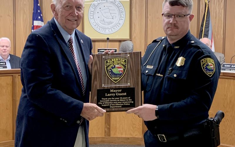 Elberton Police Chief Scott Marunich  (right) recognized Mayor Larry Guest (left) for his 16 years of service as mayor of Elberton during Monday night’s meeting. Guest’s last meeting as mayor will be the Jan. 3 meeting. (Photo by Scoggins)